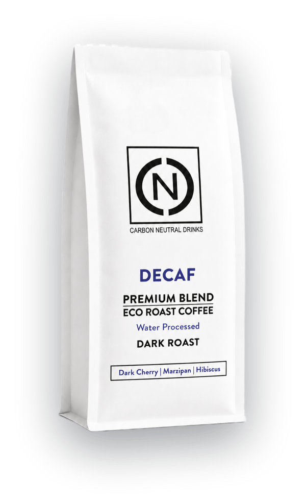 A white bag of Carbon Neutral Drinks Decaf Premium Blend Eco Roast Coffee, Dark Roast, shown on a clean white background with a soft shadow.