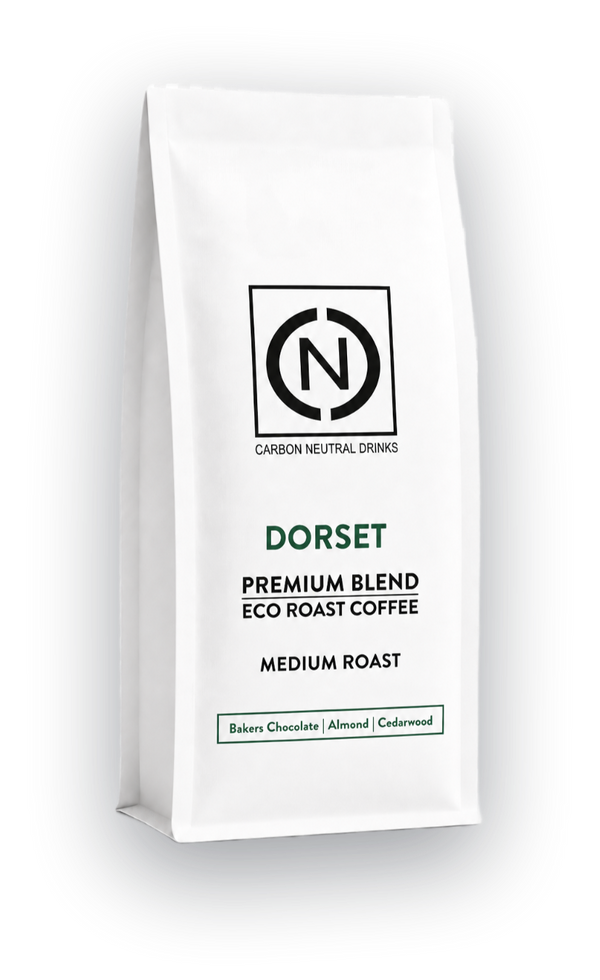 A white bag of Carbon Neutral Drinks Dorset Blend Eco Roast Coffee, Medium Roast, shown on a clean white background with a soft shadow.