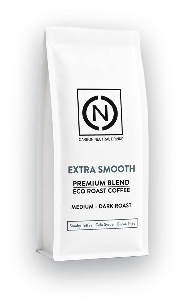 A white bag of Carbon Neutral Drinks Extra Smooth Blend Eco Roast Coffee, Medium-Dark Roast, shown on a clean white background with a soft shadow.