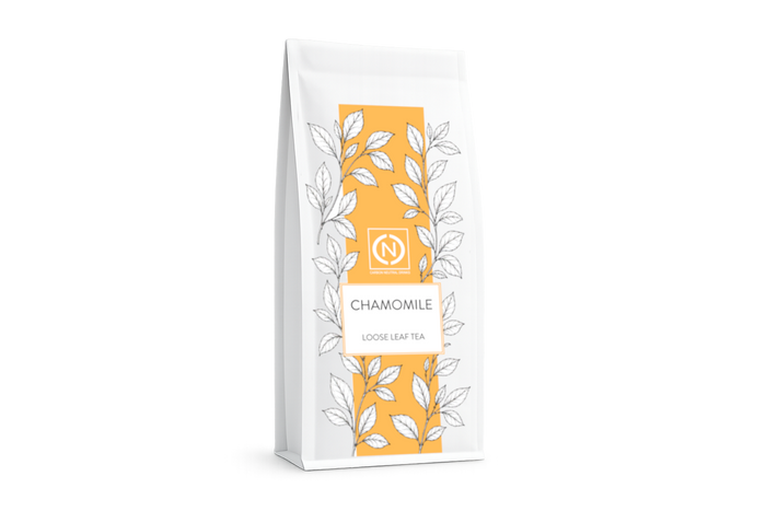 A white stand-up pouch of chamomile loose leaf tea with a prominent orange-yellow vertical label.