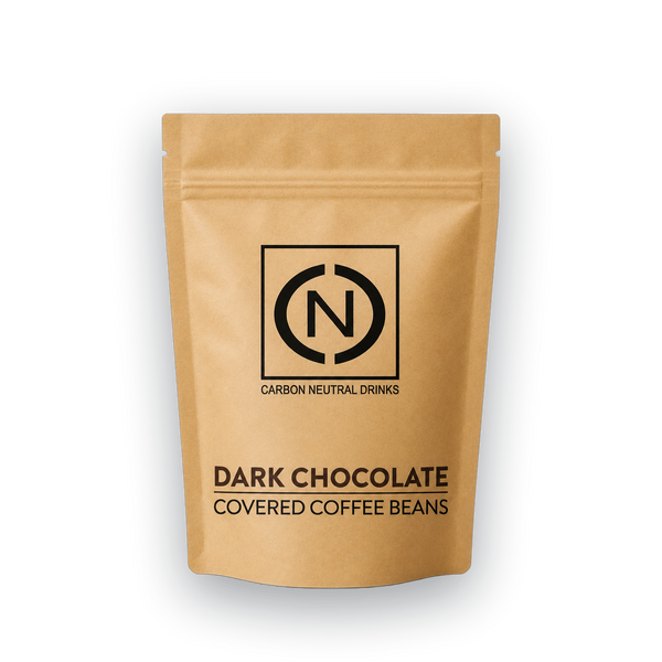 A stand-up kraft paper pouch of carbon neutral drinks dark chocolate covered coffee beans, featuring a black logo and text on a white background.
